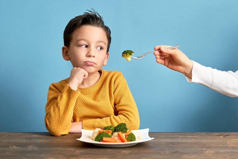 boy refusing to eat healthy food