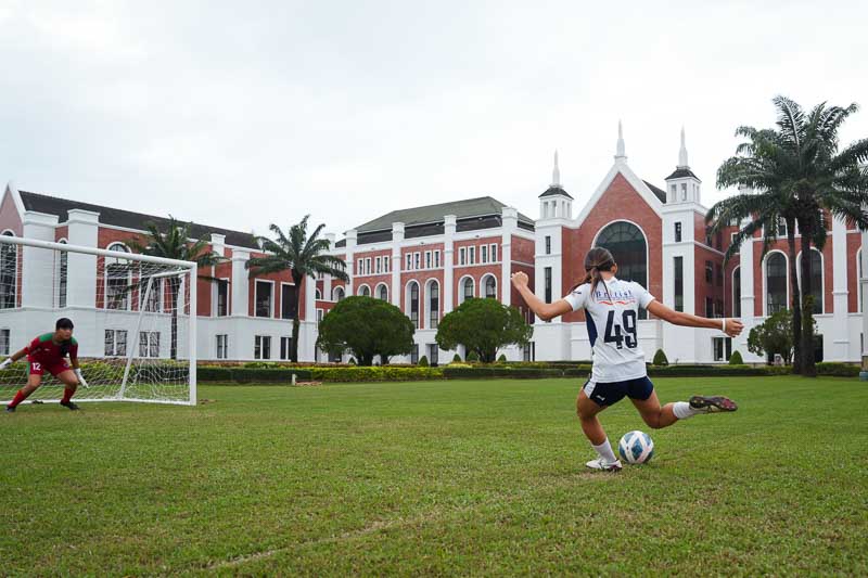 BISP campus with student playing football